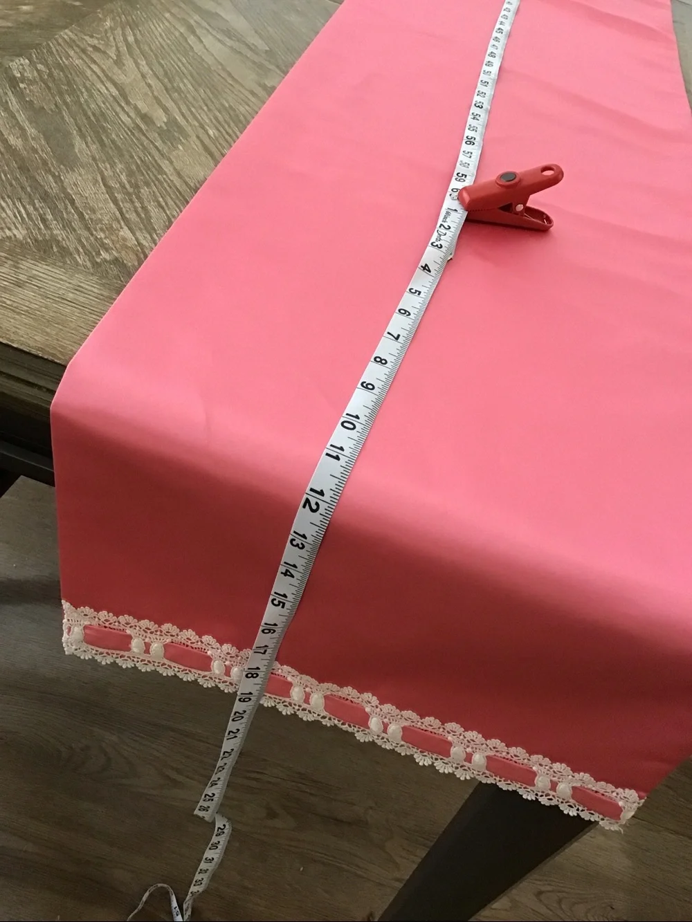 Table runner features a decorative white lace and ribbon trim